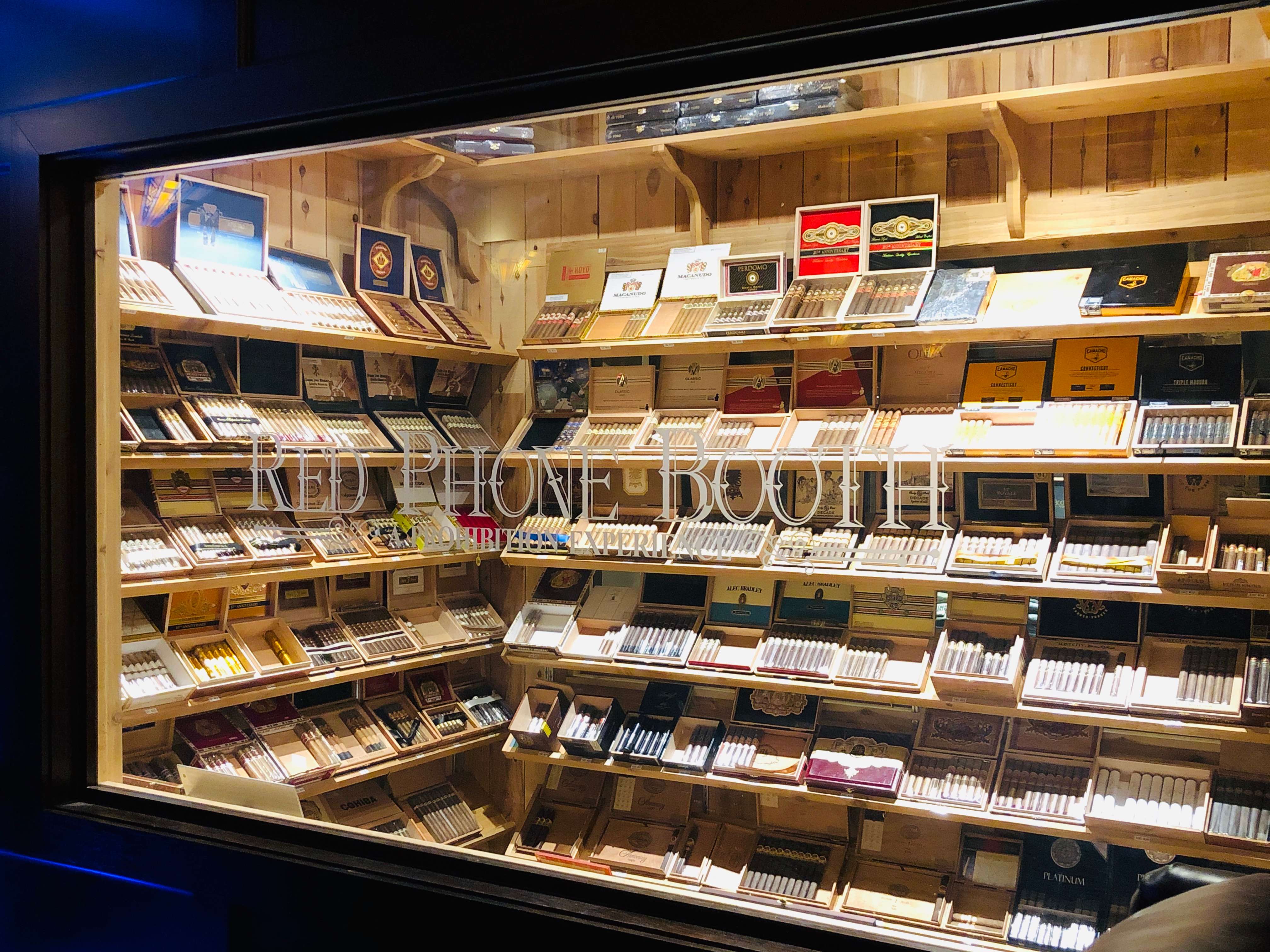 A Red Phone Booth cigar display behind etched glass.