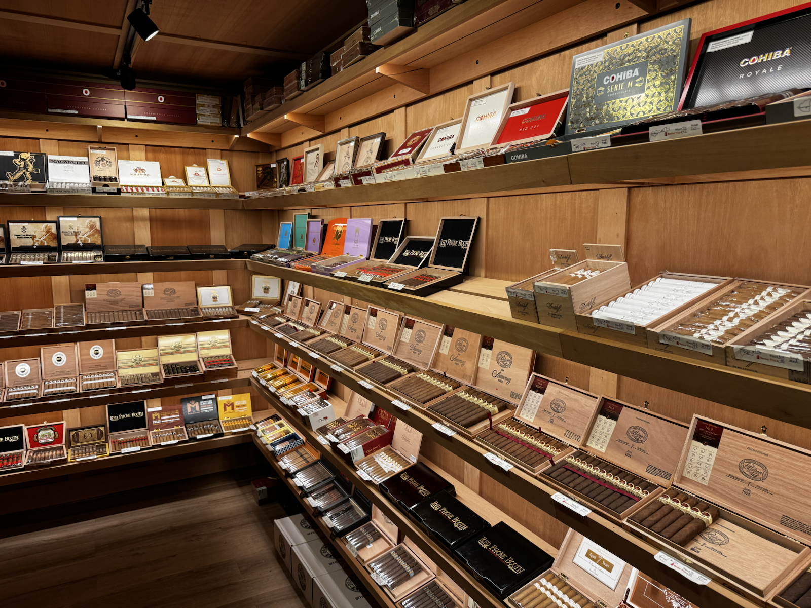 Cedar shelves of cigars inside the Red Phone Booth Durham humidor.