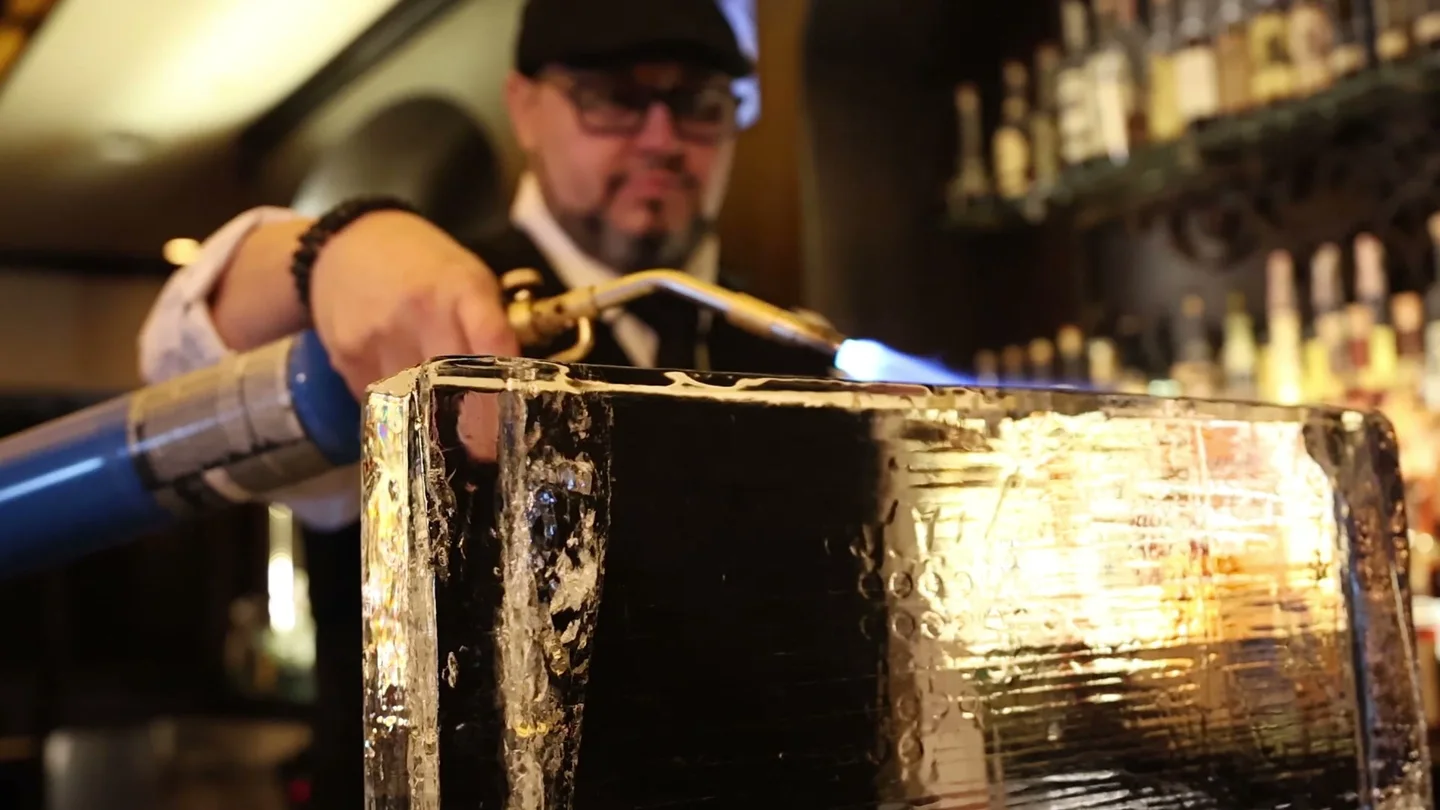 A Red Phone Booth bartender preparing a cocktail.
