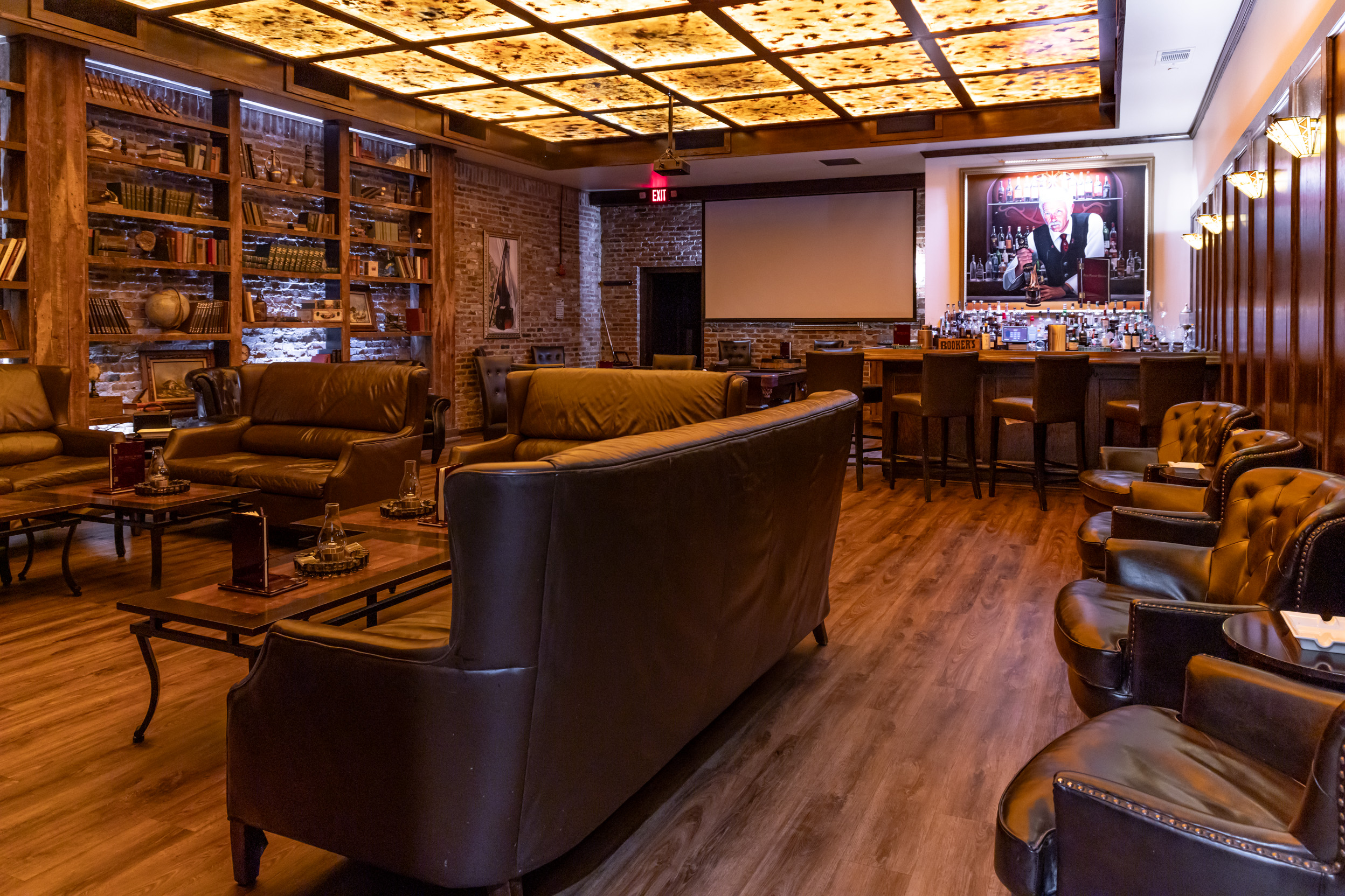 Leather seating and warm ceiling lights at Red Phone Booth Miami in Brickell.