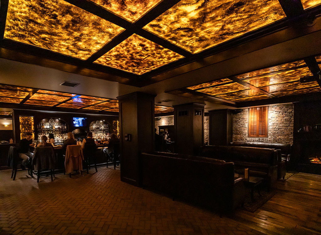 Warm ceiling lights and lounge seating at Red Phone Booth Nashville.